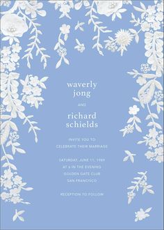 a blue and white wedding card with flowers on it