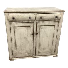 an old white cabinet with two doors and one drawer on the bottom, against a white background