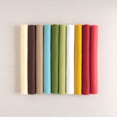 a row of different colored felts sitting on top of each other