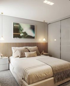 a bedroom with a large bed and white walls