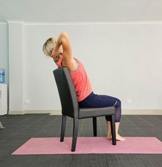 a woman sitting in a chair on top of a pink mat doing exercises for back pain