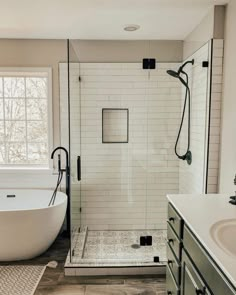 a white bath tub sitting next to a walk in shower