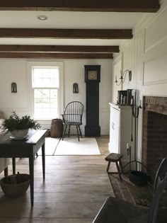 a living room filled with furniture and a fire place next to a window on the wall