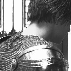 black and white photograph of a man in armor looking at something off to the side