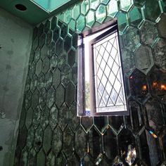 a window is shown in the middle of a wall with hexagonal tiles on it