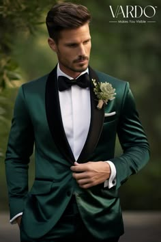 a man in a green tuxedo with a black bow tie and white shirt