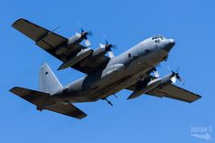 an air plane flying in the sky with propellers on it's wings and four propeller engines