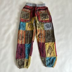 Not Sure How To Even Describe These Unique Pants! 100% Cotton. Striped Colorful Pants With Lots Of Various Graphics And Symbols. Peace Sign, Sunshine, Spirals, Ethnic. Nwt. Size Small. Zipper And Front Velcro Pockets! Bin 1 Red Cotton Ankle-length Harem Pants, Red Ankle-length Cotton Harem Pants, Multicolor Patchwork Relaxed Fit Bottoms, Multicolor Relaxed Fit Pants With Pockets, Relaxed Fit Multicolor Pants With Pockets, Casual Multicolor Patchwork Pants, Casual Multicolor Pants With Elastic Waistband, Casual Multicolor Patchwork Bottoms, Casual Cotton Bottoms With Colorful Pattern