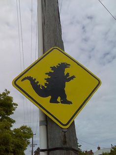 a yellow and black sign that is on a pole