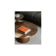 a coffee table with an orange book on top