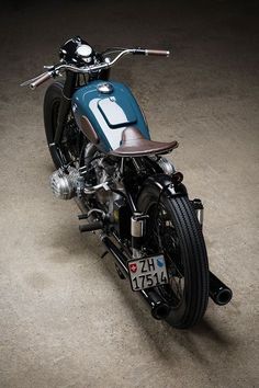 a blue motorcycle parked on top of a cement floor