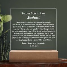 a plaque with the words to our son in law michael on it and a potted plant