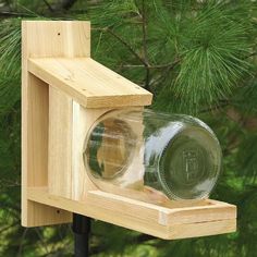 The Glass Jar Cedar Squirrel Feeder has a weather resistant cedar frame that easily attaches to a tree or post with the included screws. The thick glass jar is removable for filling and has a 4 inch opening. Capacity: 2 quart glass jar Tree or post mount Made from weather resistant cedar Dimensions: 18" L x 5.5" W x 15" H Weight: 3 lb Made in the USA Squirrel Feeder Diy, Squirrel Feeders, Squirrel Feeder, Pickle Jar, Bird House Kits, Bird Aviary, Diy Bird Feeder, Diy Birds, Bird Houses Diy