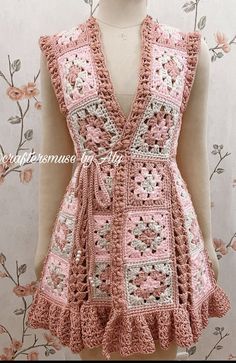 a pink crocheted vest is on display