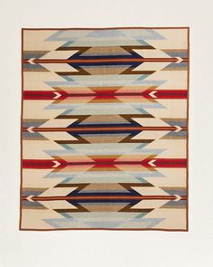 an old navajo rug with red, blue and brown stripes on it's sides