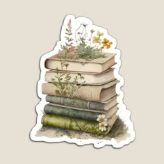 a stack of books sitting on top of each other with flowers growing out of them