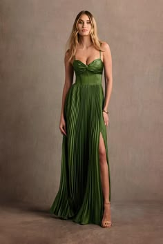 a woman in a green dress posing for the camera