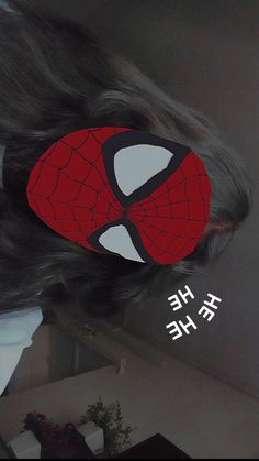 there is a spider man mask on top of a woman's head with the words he he