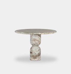 a white marble table with a round base