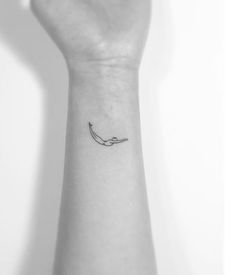 a person's arm with a small tattoo on the left side of their wrist