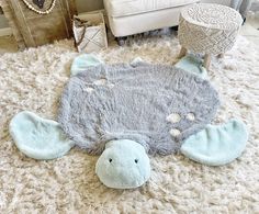 a stuffed animal laying on top of a white rug