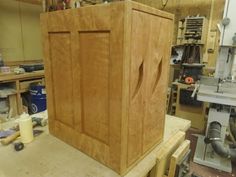 a large wooden cabinet sitting on top of a workbench