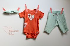 two baby onesuits hanging on clothesline with the words style live written below them