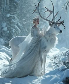 a woman in white dress standing next to an animal with antlers on its back