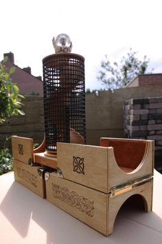 a wooden bird feeder sitting on top of a table