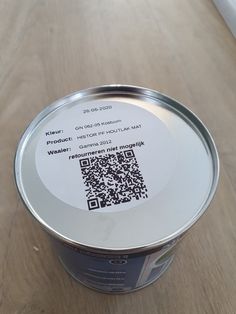 a can of food with a qr code on the lid sitting on a table