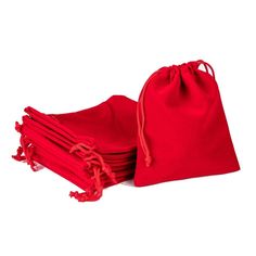 four red bags are sitting next to each other on a white surface, one is folded up and the other is closed