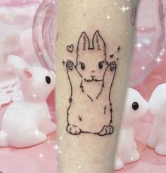 a tattoo on the leg of a person with an image of a cat and hearts