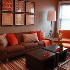 a living room filled with furniture and pictures on the wall above it's coffee table