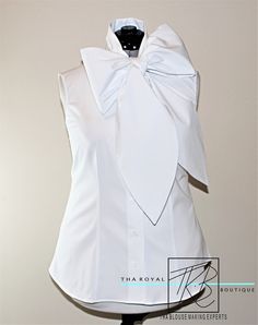 Summer is here and Bow Blouses are in. For a stunning mix in fashion and romance, the bow blouse, is a perfect example of a blouse that can maintain a business look while still sporting an air of pleasantry. The bow neckline adds a soft, feminine touch and you will defiantly impress others with this custom sleeveless bow blouse. The blouse has a tailor fit and is very comfortable to wear. Made of 100% Poly Poplin, light weight, slight stretch, and easy care. 97% Cotton, 3% Lycra The blouse featu Long Bow, Outfit Short, Sleeveless Tops Summer, Womens Sleeveless Tops, Soft Feminine, Bow Blouse, Sleeveless Tops, Summer Is Here, Large Bow