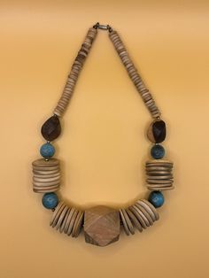 Chunky wooden Bohemian beaded statement necklace.  Made of carved wood, brass beads, variegated sandstone shades and soft turquoise blue.  Vintage. Length 8.5", Weight 2.4 oz. Pre-Owned with some surface wear commensurate with age. Soft Turquoise, Necklace Wood, Wooden Bead Necklaces, Beaded Statement Necklace, Bleu Turquoise, Blue Vintage, Necklace Vintage, Wooden Beads, Turquoise Blue