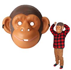 a man standing next to a fake monkey mask with his hands on his head,