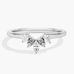 a white gold ring with three pear shaped diamonds