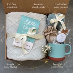 the gift box contains two mugs, a blanket and some other things to put in it