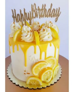 a birthday cake decorated with lemons and white frosting