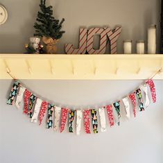 a christmas garland hanging from a mantle