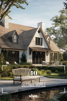 a large white house sitting next to a pond with a bench in front of it