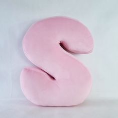 a pink pillow shaped like the letter s