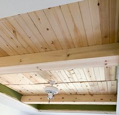 a ceiling with wood planks and a light fixture