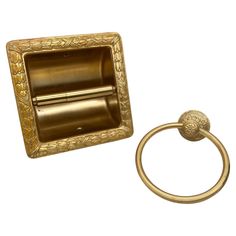 an antique brass toilet paper holder and ring