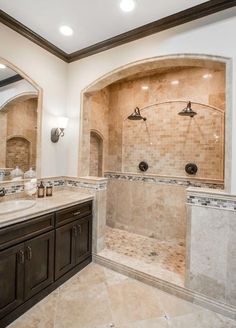 a large bathroom with two sinks and a walk in shower