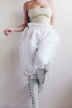 "Rare unique pair of quilted pants with an elastic waist.  Color: white  Material: cotton  Condition: light wear  Size: femme small Waist lying flat 13\" -15\" Hips: 26\" Length: 42\"" Summer Ruffled Bloomers For Daywear, Cotton Ruffled Bloomers, White Ruffled Pants For Summer, White Wide-leg Pants With Ruffles, White Wide Leg Pants With Ruffles, Wide Leg Ruffled Bottoms For Loungewear, Wide Leg Ruffled Pants For Loungewear, High Waist Cotton Pants With Ruffles, Wide Leg Ruffle Pants For Loungewear