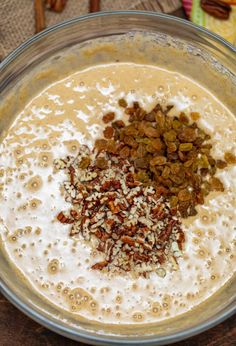 a bowl filled with oatmeal and nuts on top of a wooden table