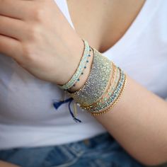 Gold Vermeil Chain and Aqua Silk Woven Bracelet with Crystal Bead Detail and Sliding Adjustable Closure. Bracelet measures 0.25" wide.