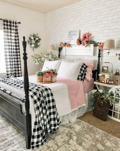 a white brick wall in a bedroom with black and white bedding, plaid bedspread