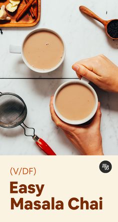 two cups of coffee sitting on top of a table